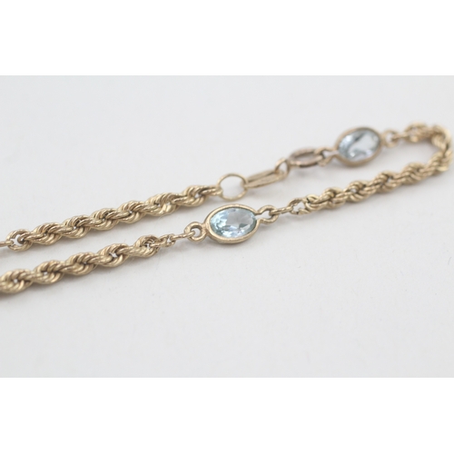 62 - 9ct gold topaz twisted link bracelet (1.8g)