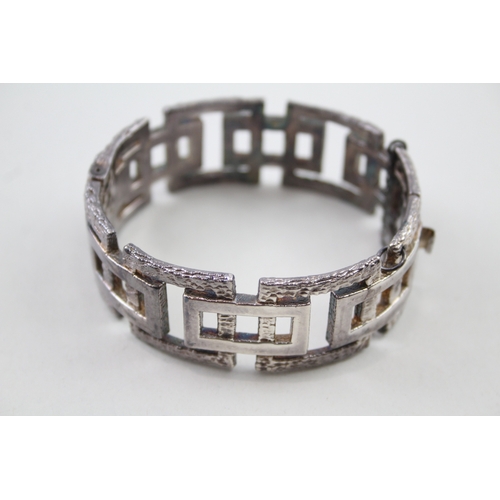 208 - Silver mid-century modernist bangle with textured design