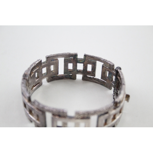 208 - Silver mid-century modernist bangle with textured design