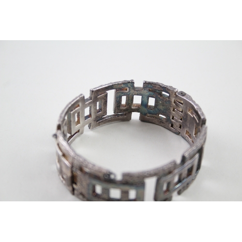 208 - Silver mid-century modernist bangle with textured design