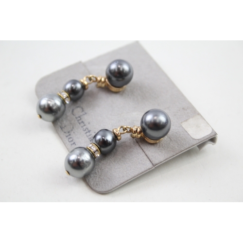 216 - Pair of gold tone simulated pearl drop earrings by designer Christian Dior