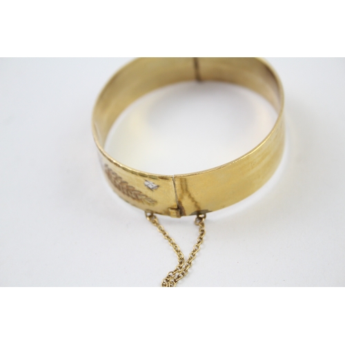 226 - Rolled gold bangle with floral design