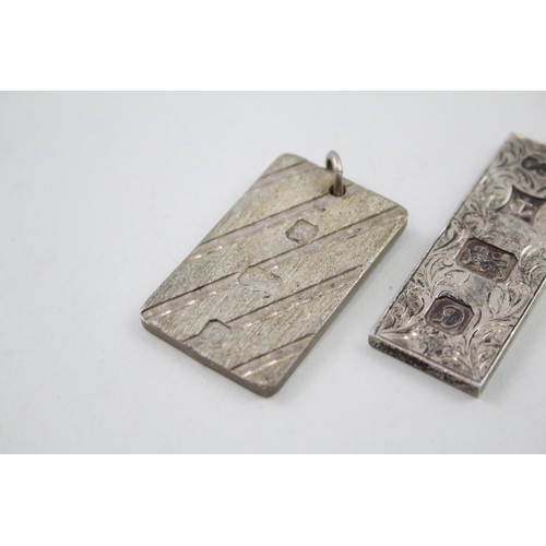 228 - Two silver ingot pendants 1978 with etched designs