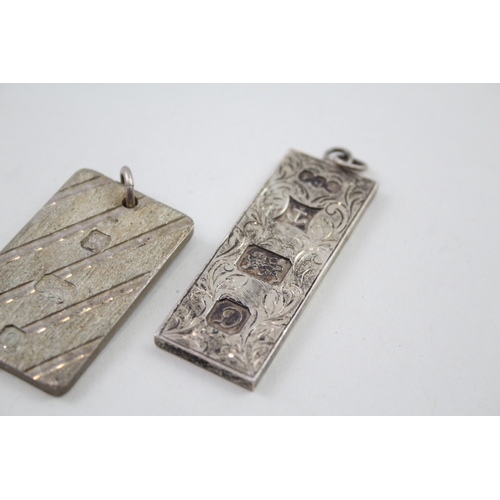 228 - Two silver ingot pendants 1978 with etched designs