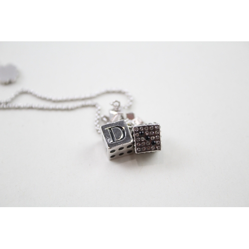 235 - Silver tone dice charm bracelet by designer Christian Dior