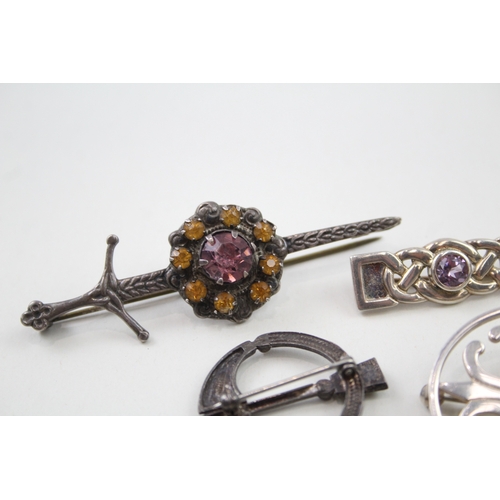 238 - Five silver Scottish/Celtic brooches including gemstone