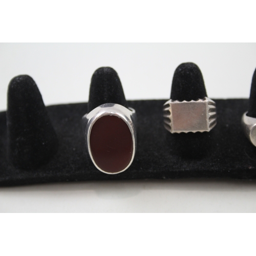 242 - Four silver gents rings including Carnelian