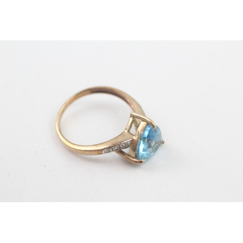 68 - 9ct gold trillion topaz single stone ring with diamond set shoulders (2.5g) Size  N