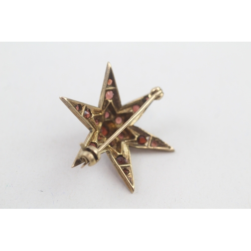 74 - 9ct gold vintage garnet star brooch (3.4g)