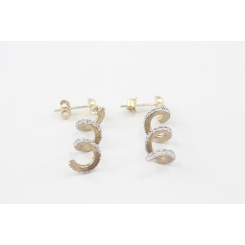 83 - 9ct gold cubic zirconia twist drop earrings (4.2g)