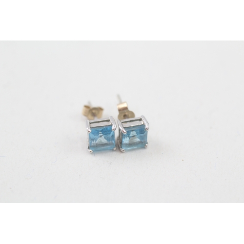 154 - 9ct gold square cut blue topaz stud earrings (1g)