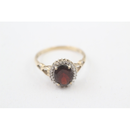 208 - 9ct gold diamond & garnet oval halo ring (2.3g) Size  P