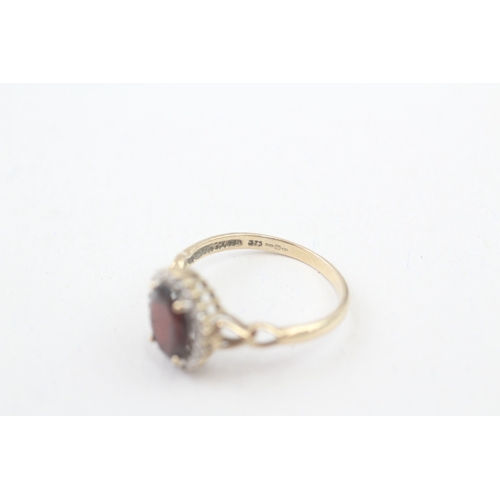 208 - 9ct gold diamond & garnet oval halo ring (2.3g) Size  P