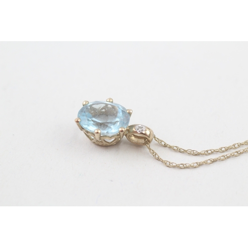 22 - 9ct gold blue topaz & diamond pendant necklace with a heart shape gallery (2.8g)