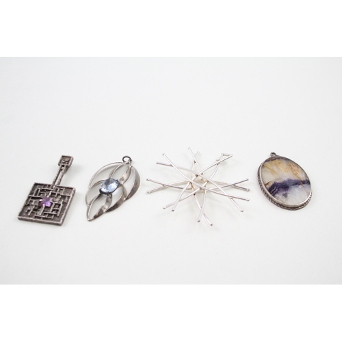 243 - Four silver modernist pendants including Blue John