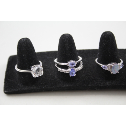 244 - A collection of silver gemstone rings including Opal doublet