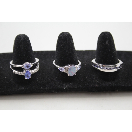 244 - A collection of silver gemstone rings including Opal doublet