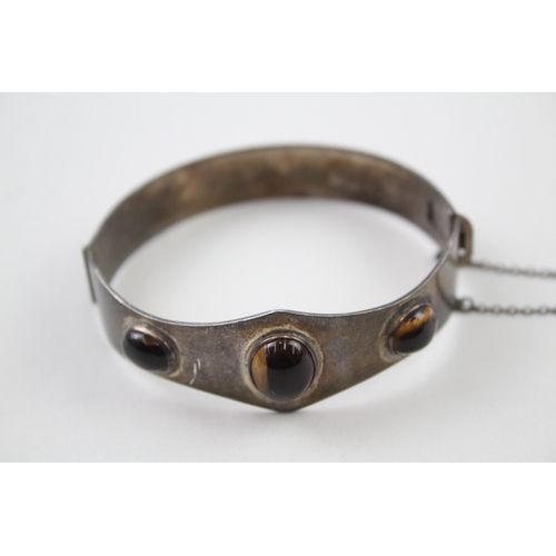 271 - Silver mid-century bangle by Excalibur with tigers eye