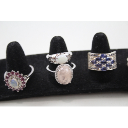 274 - A collection of silver gemstone rings including Opal