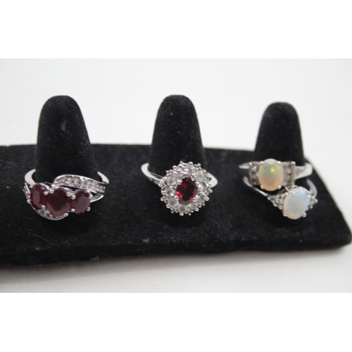 274 - A collection of silver gemstone rings including Opal