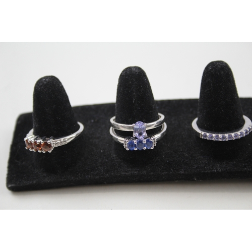 284 - A collection of silver gemstone rings including Topaz