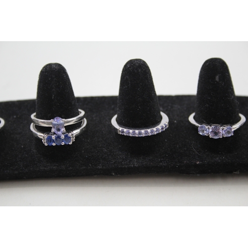 284 - A collection of silver gemstone rings including Topaz