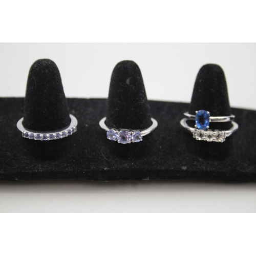 284 - A collection of silver gemstone rings including Topaz