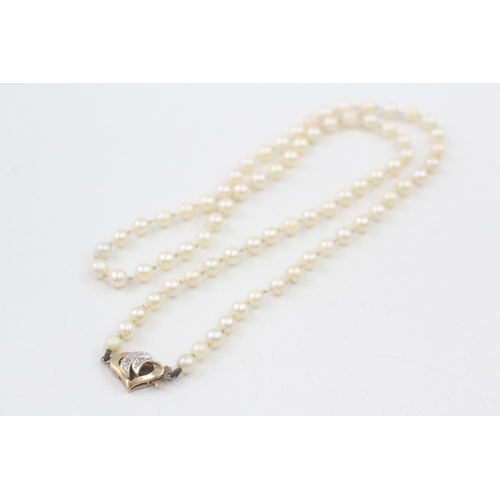 38 - 9ct gold diamond set clasp cultured pearl necklace (11.8g)