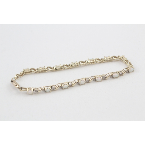 41 - 9ct gold opal and diamond tennis bracelet (6.7g)