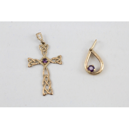 63 - 2x 9ct gold amethyst pendants including a celtic cross (2.1g)