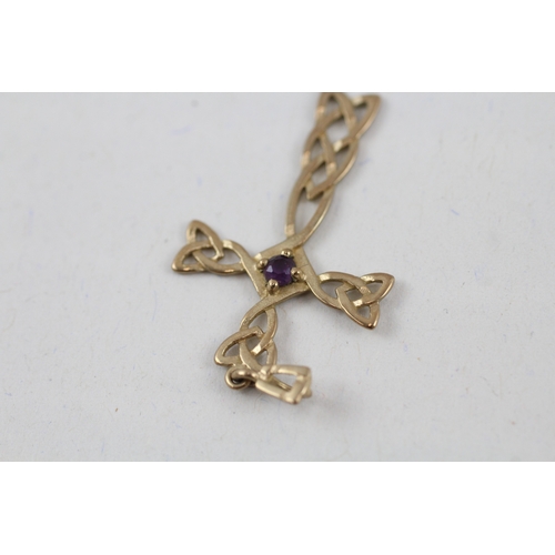 63 - 2x 9ct gold amethyst pendants including a celtic cross (2.1g)