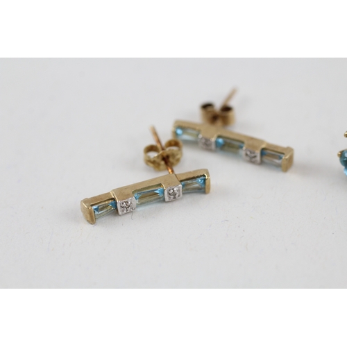 81 - 2x 9ct gold blue topaz & diamond earrings with scroll backs (2.9g)