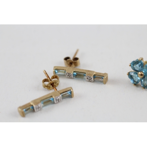 81 - 2x 9ct gold blue topaz & diamond earrings with scroll backs (2.9g)