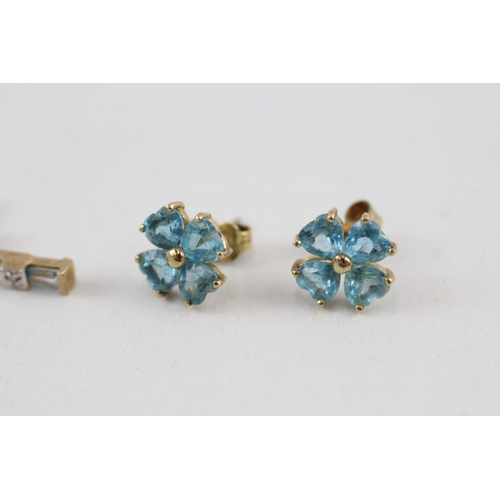 81 - 2x 9ct gold blue topaz & diamond earrings with scroll backs (2.9g)