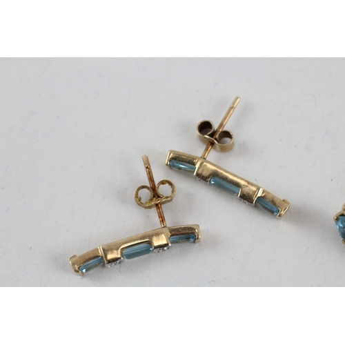 81 - 2x 9ct gold blue topaz & diamond earrings with scroll backs (2.9g)