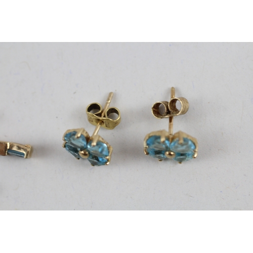 81 - 2x 9ct gold blue topaz & diamond earrings with scroll backs (2.9g)