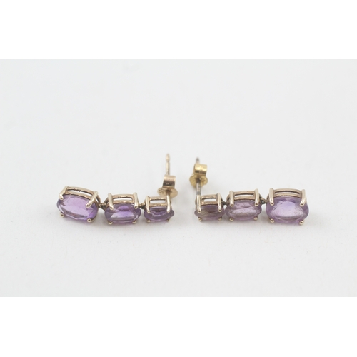 91 - 9ct gold graduated oval cut amethyst drop earrings (1.6g)