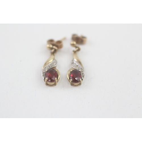 55 - 9ct gold oval cut garnet & diamond drop earrings with scroll backs (1.9g)