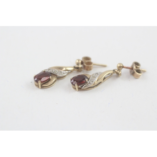 55 - 9ct gold oval cut garnet & diamond drop earrings with scroll backs (1.9g)