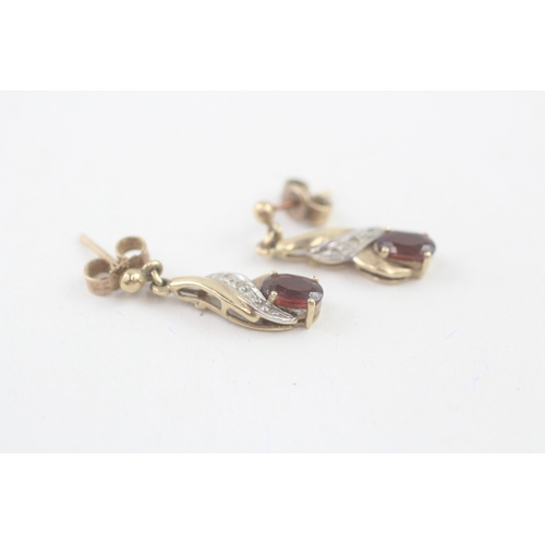 55 - 9ct gold oval cut garnet & diamond drop earrings with scroll backs (1.9g)