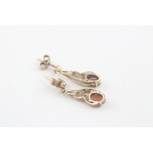 55 - 9ct gold oval cut garnet & diamond drop earrings with scroll backs (1.9g)