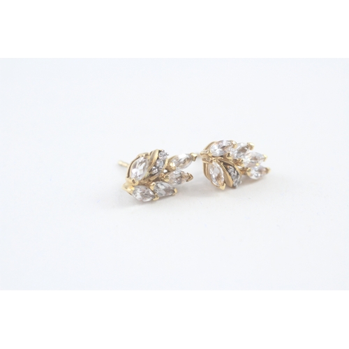 69 - 2x 9ct gold cubic zirconia stud earrings with scroll backs (3.3g)