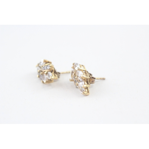 69 - 2x 9ct gold cubic zirconia stud earrings with scroll backs (3.3g)