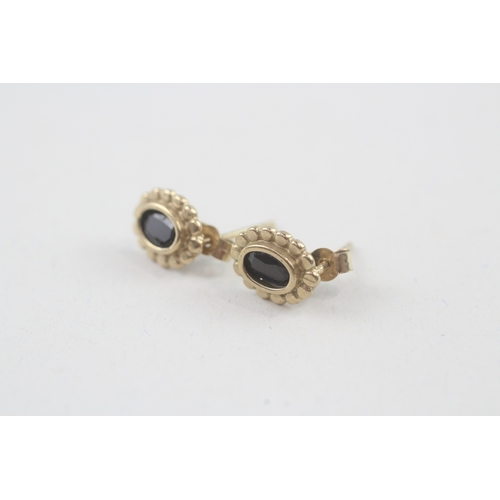 71 - 2x 9ct gold sapphire earrings with scroll backs (2.1g)