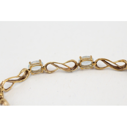 89 - 9ct gold topaz and diamond set line bracelet (5.8g)