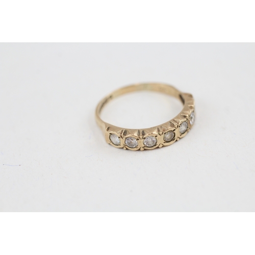 91 - 9ct gold cubic zirconia seven stone eternity ring (1.8g) Size  M