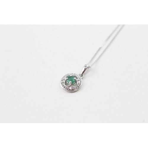 61 - 9ct white gold emerald and diamond halo pendant with 9ct white gold chain (1g)