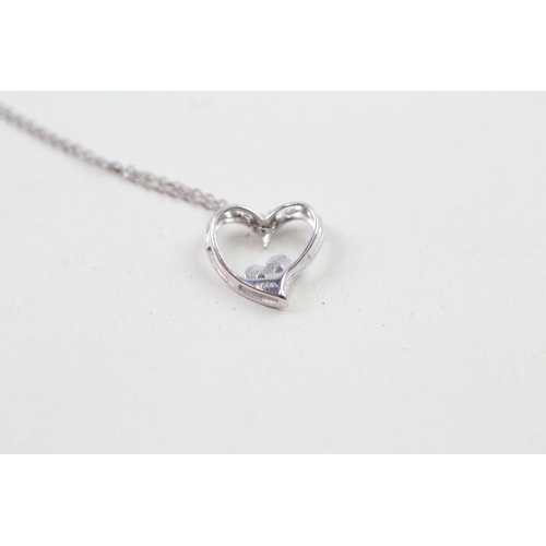 97 - 9ct white gold diamond set heart pendant with 9ct white gold chain (1.1g)