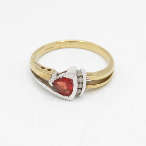 114 - 9ct gold diamond and red gemstone dress ring (3g) Size  O