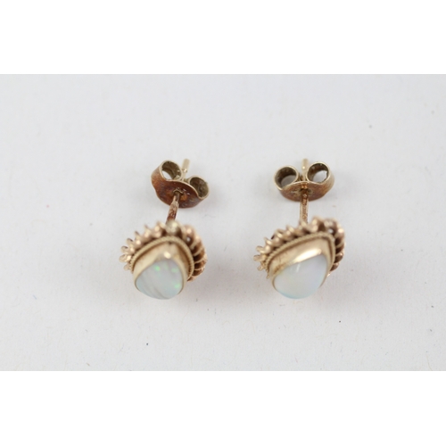 147 - 9ct gold pear cut opal stud earrings with scroll backs (1.4g)